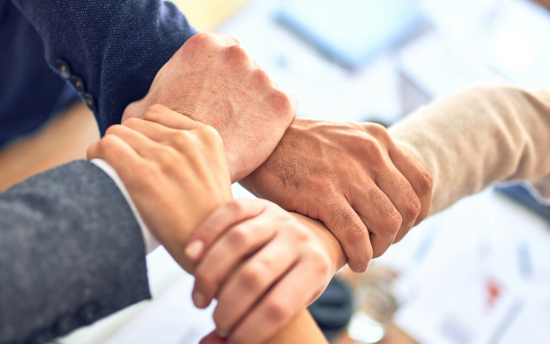 person in black long sleeve shirt holding persons hand